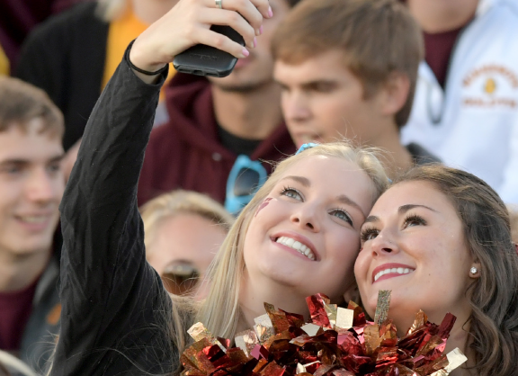 Two UMD students take a selfie at a football game