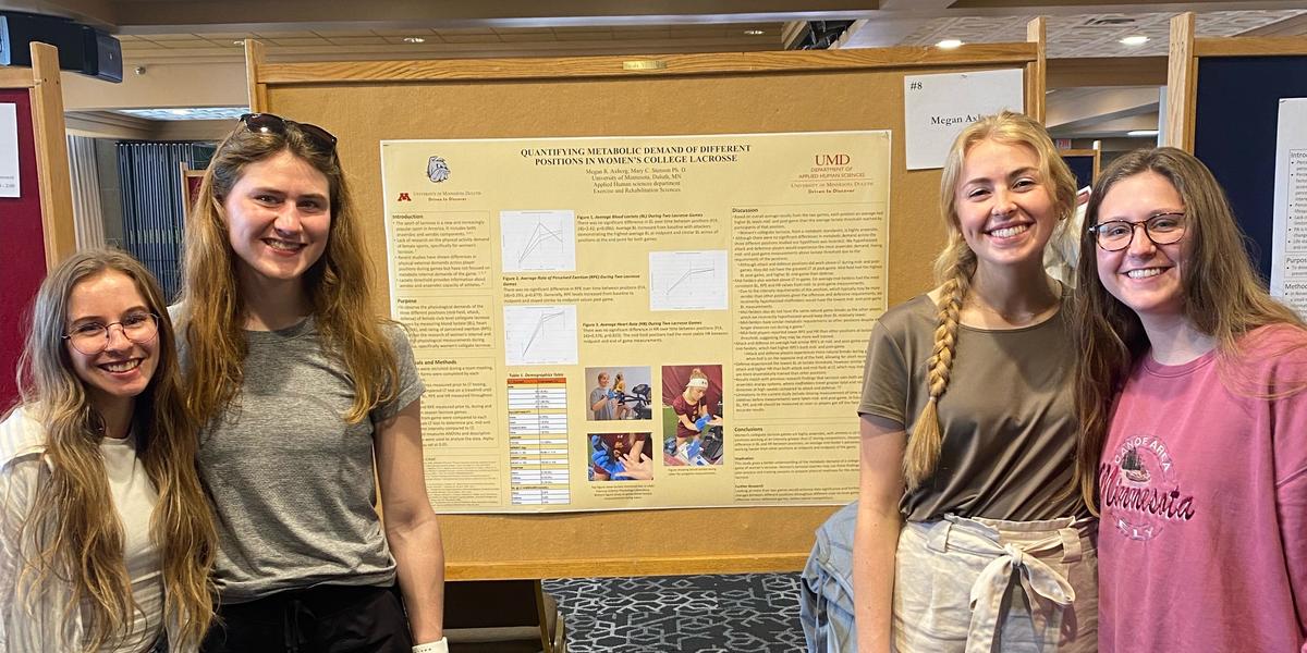 Megan Axberg presenting at the spring UROP showcase with her friends/supporters.