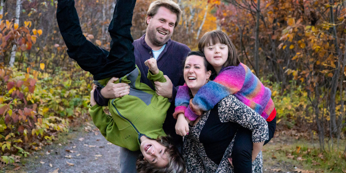 Danielle, her husband, and 2 kids smiling and laughing