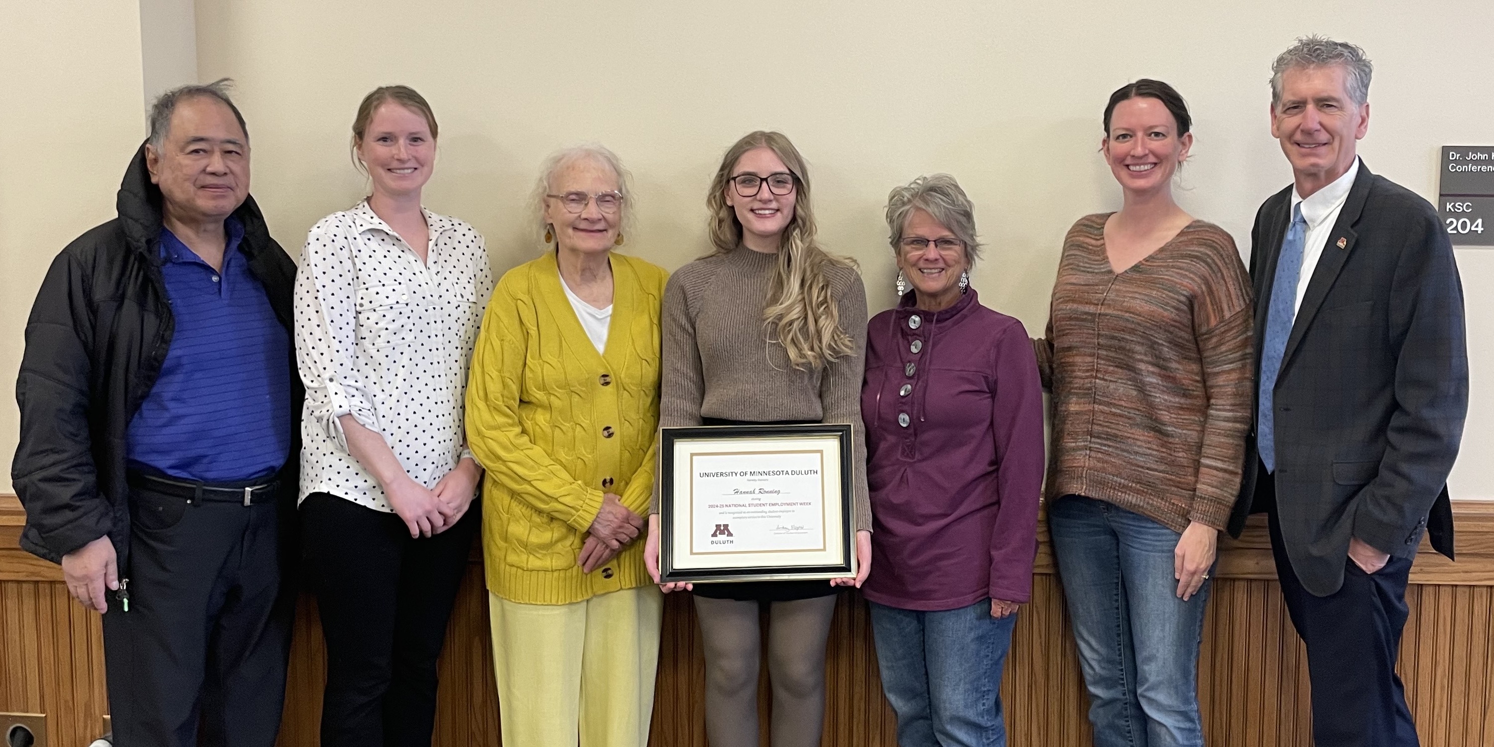 CSD faculty and chancellor nies frame Hannah ronning in the center as she holds her award